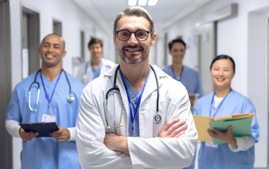 Produk Pelayanan 1 diverse medical team of doctors looking at camera while holding clipboard and medical files