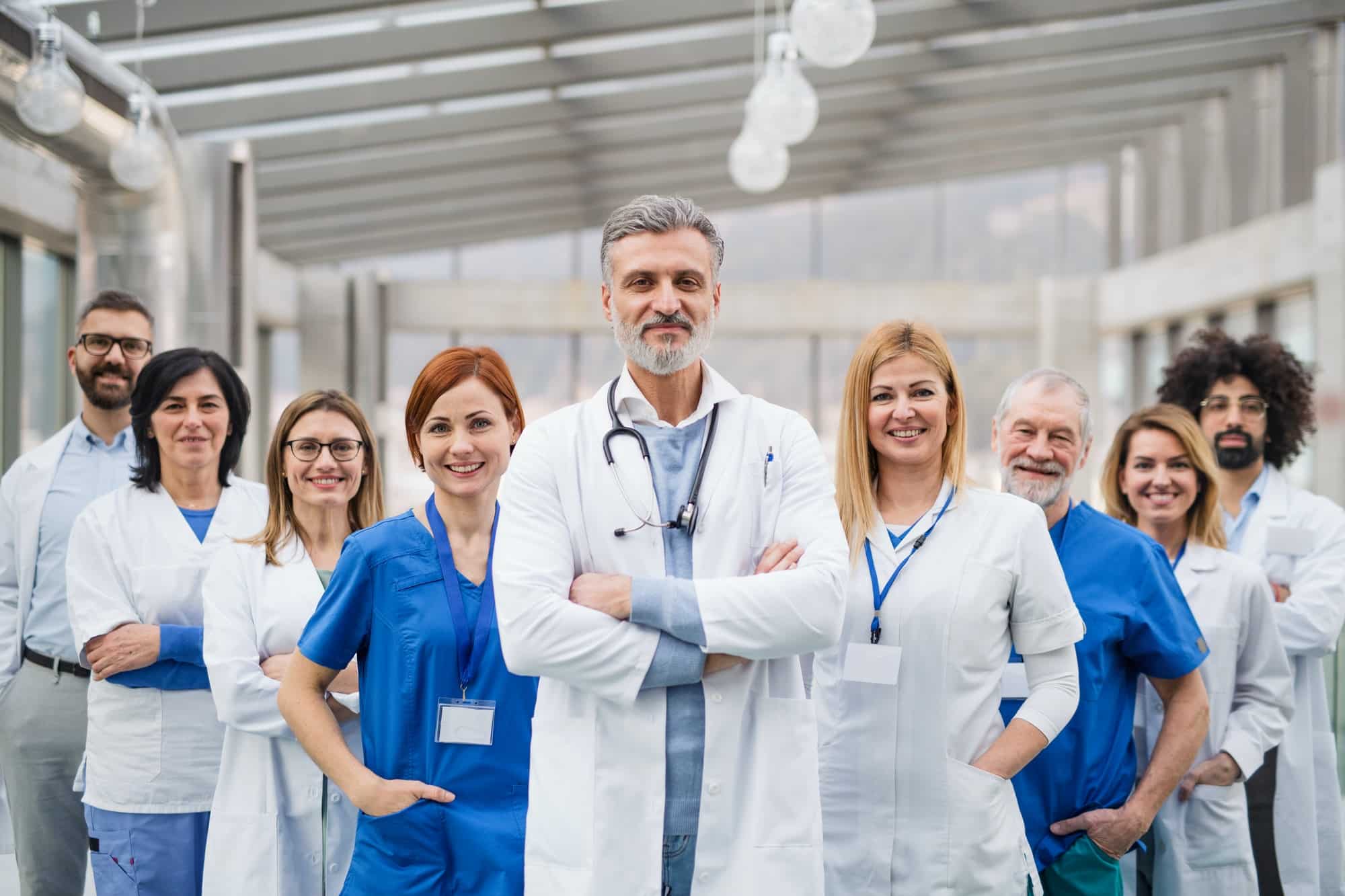 Pengaduan 2 group of doctors standing in hospital on medical conference